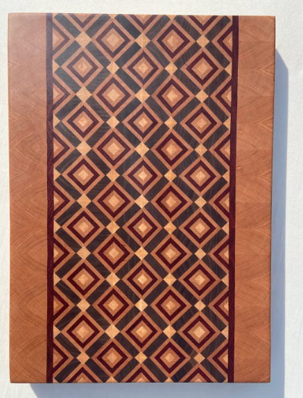 Finished diamond end-grain cutting board with light accent diamonds between larger patterns